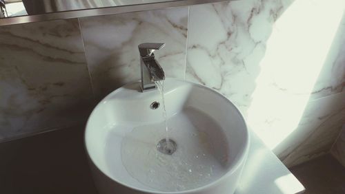 Close-up of faucet in bathroom at home