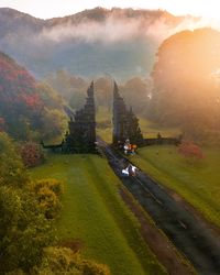 Couple dancing in the middle of the road in fromt of bali famous gate