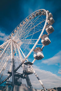 Low angle view of ferris wheel against sky