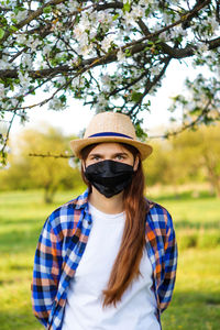 Portrait of young woman wearing black face mask. dust protection against virus. coronavirus pandemic