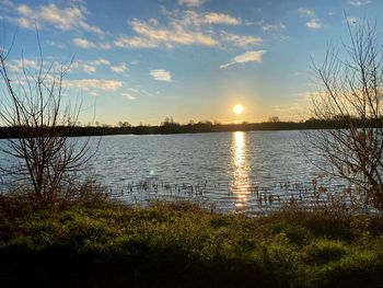 Scenic view of lake against sky during sunset