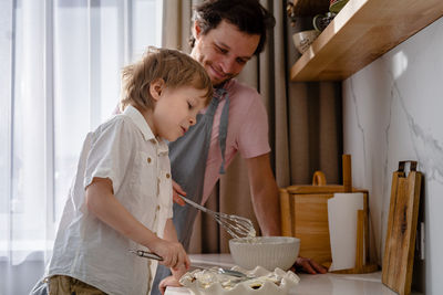 Father and son standing in bowl