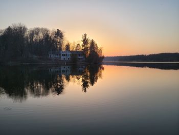 Scenic view of lake against sky at sunset