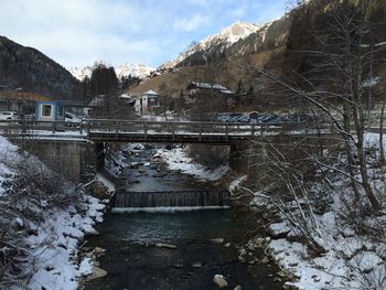 Bridge over river against sky during winter