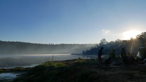 Panoramic view of people on land against clear sky