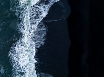 Iceland black sand beach with huge waves at reynisfjara vik.