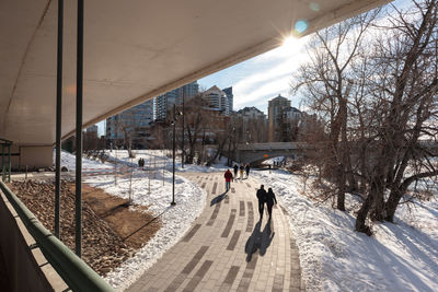 People walking on snow covered landscape