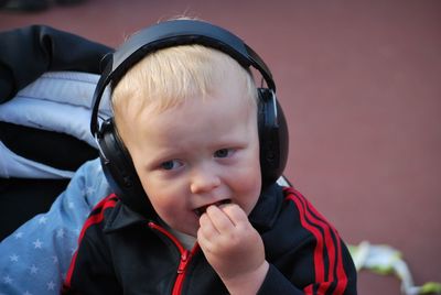 Close-up of cute boy listening music on headphones