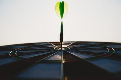 Close-up of white umbrella against green background
