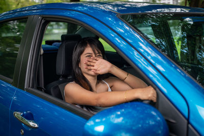 Portrait of woman sitting in car