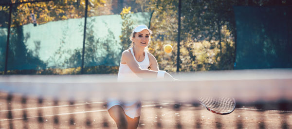 Woman playing tennis at playing field