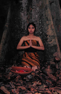 Portrait of a young woman sitting outdoors