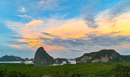 Scenic view of land against sky during sunset