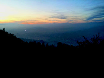 Silhouette of mountain against sky at sunset