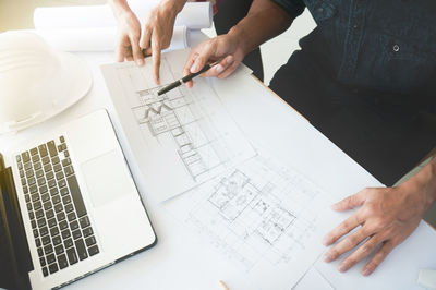 High angle view of people working on table