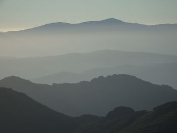 Scenic view of silhouette mountains against sky