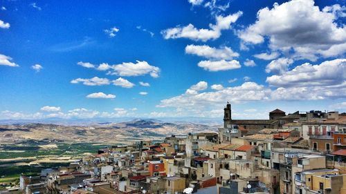 High angle view of cityscape against blue sky