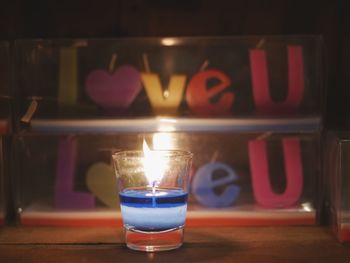 Close-up of illuminated candles on table