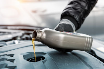 Cropped hand of man repairing car