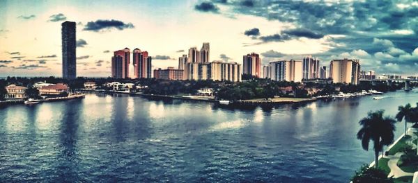 Cityscape against cloudy sky