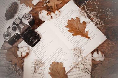 High angle view of hand holding book on table