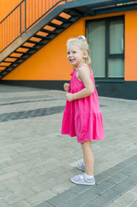 Portrait of young woman walking on street