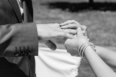 Midsection of couple holding hands