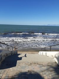 Scenic view of sea against clear blue sky