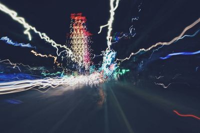 Light trails on road in city at night