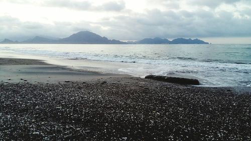 Scenic view of sea against cloudy sky