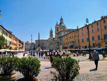 Group of people in front of buildings in city