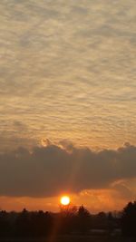 Scenic view of silhouette landscape against orange sky