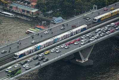 High angle view of trains and vehicles over the river