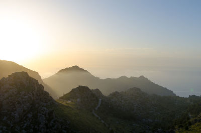 Scenic view of mountains against sky at sunset