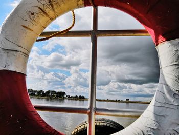 Close-up of river against sky seen through window