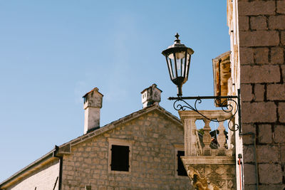 Low angle view of street light against building