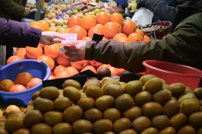 People exchanging money at market stall