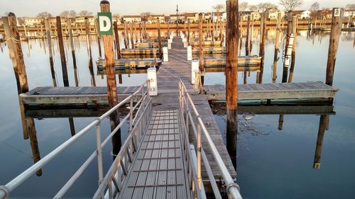 Wooden pier over sea against sky