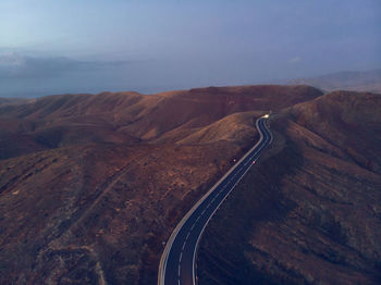 Road amidst mountain against sky