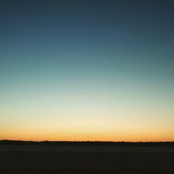 Scenic view of silhouette landscape against clear sky during sunset