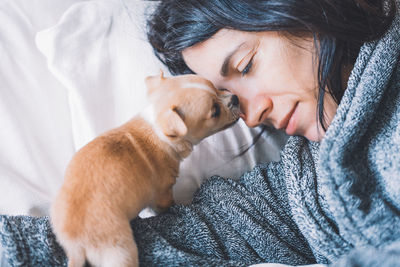 Midsection of a dog sleeping on bed