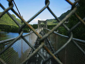 Bridge over river seen through chainlink fence