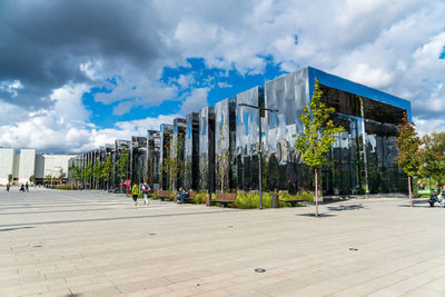 Panoramic view of street amidst buildings against sky