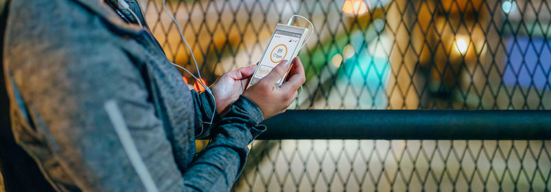 Midsection of woman using mobile phone