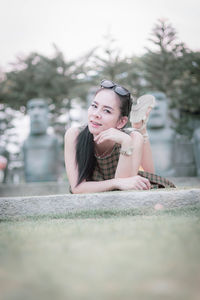 Portrait of smiling woman relaxing in park