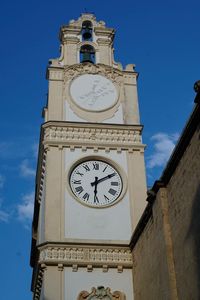 Low angle view of clock tower against sky