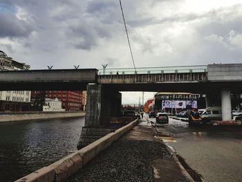 Bridge over street in city against sky