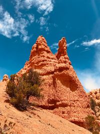 Low angle view of rock formations against sky