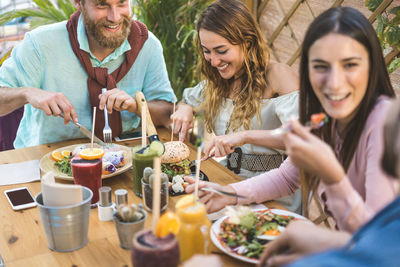 Group of people having food at table