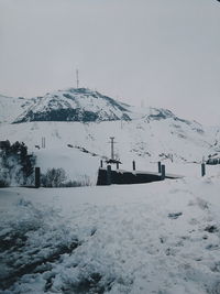 Snow covered landscape against sky